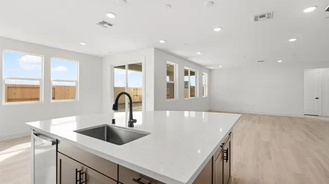 a kitchen with stainless steel appliances granite countertop a stove and a refrigerator