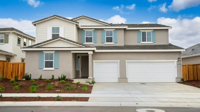 a front view of a house with garage and garage