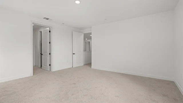 a view of walk in closet with empty racks