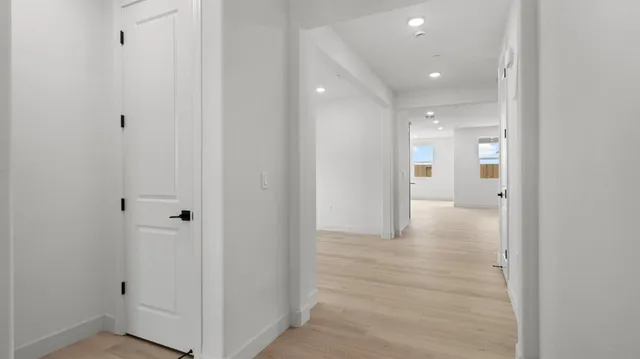 a view of a hallway with wooden floor