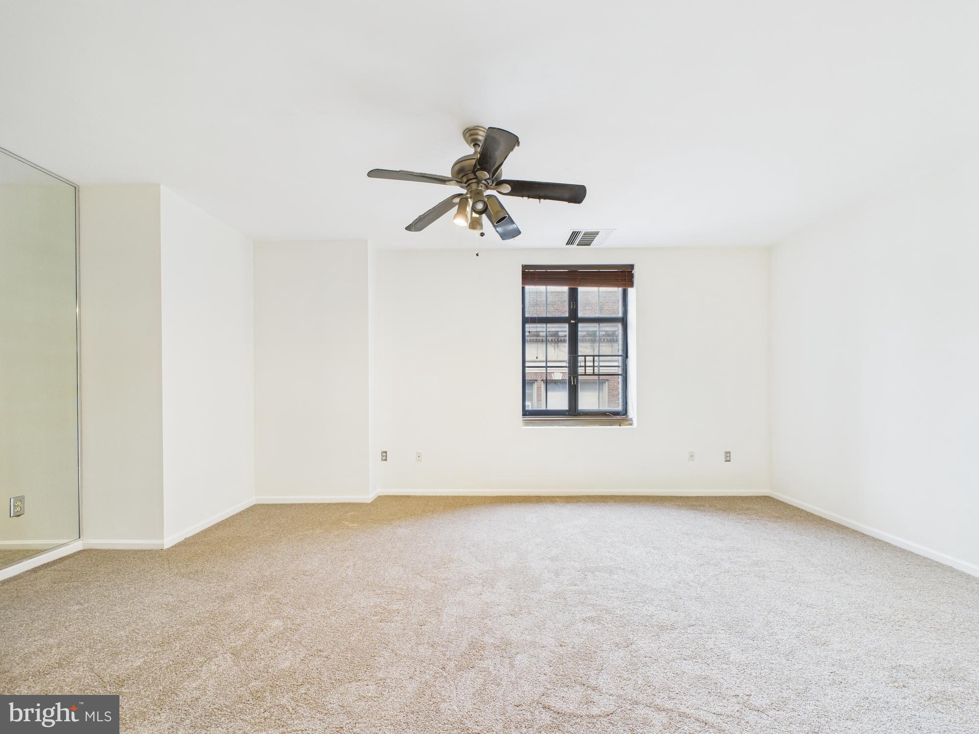 1601 Spring Garden Street, Unit 402 Philadelphia, PA 19130 - Photo 13 of 22 an empty room with windows and fan