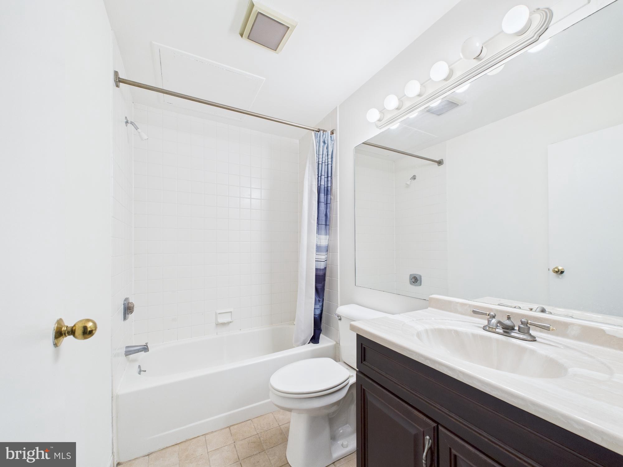 1601 Spring Garden Street, Unit 402 Philadelphia, PA 19130 - Photo 16 of 22 a bathroom with a sink a toilet and shower