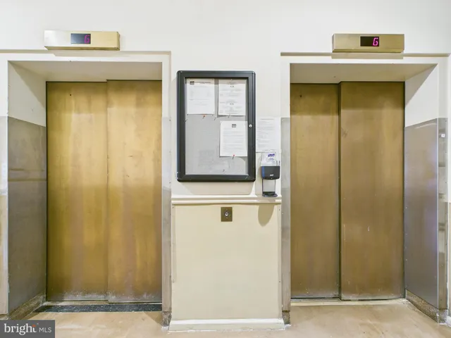 a view of a hallway with wooden door