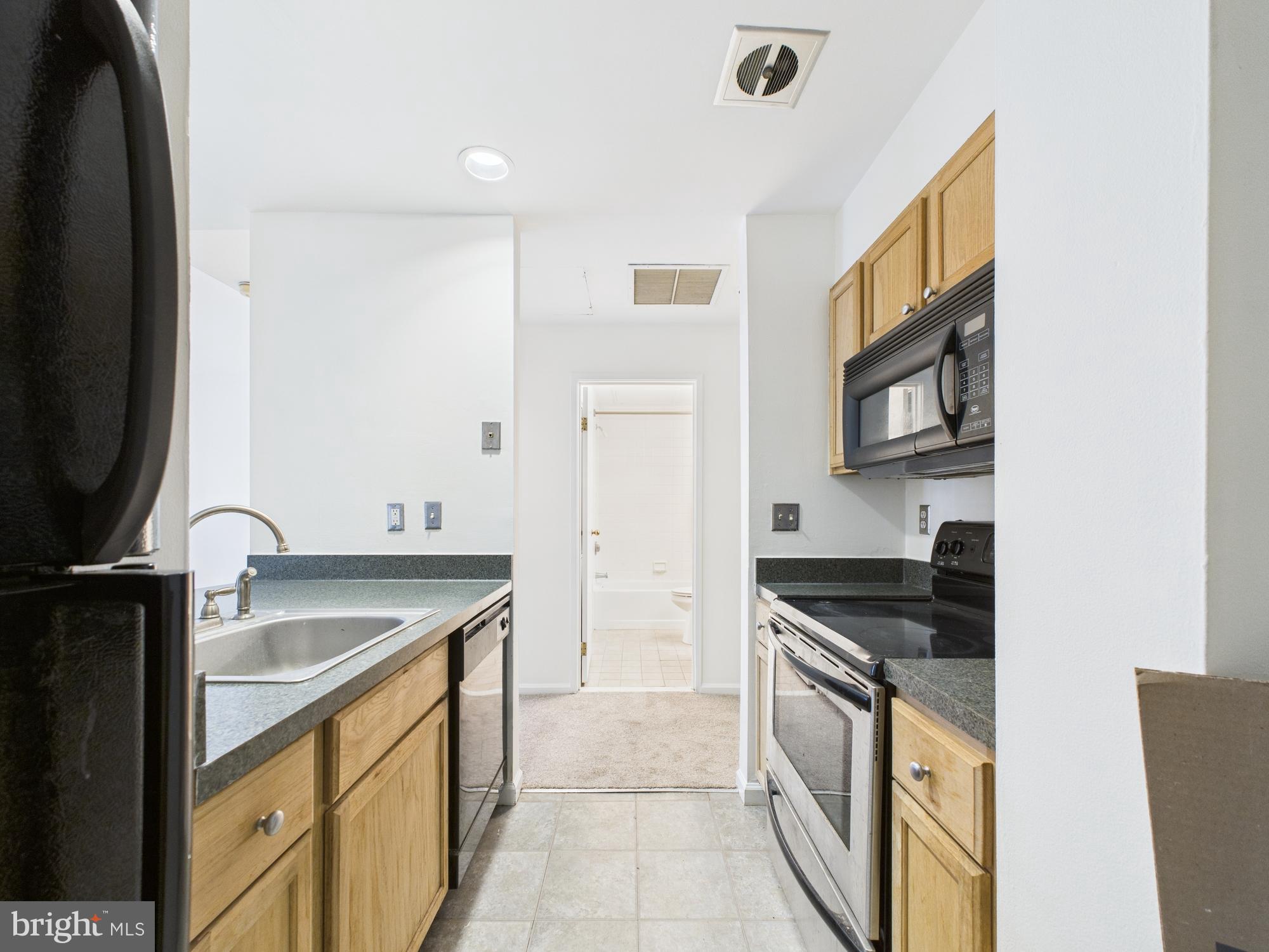 1601 Spring Garden Street, Unit 402 Philadelphia, PA 19130 - Photo 9 of 22 a kitchen with a sink stove and cabinets