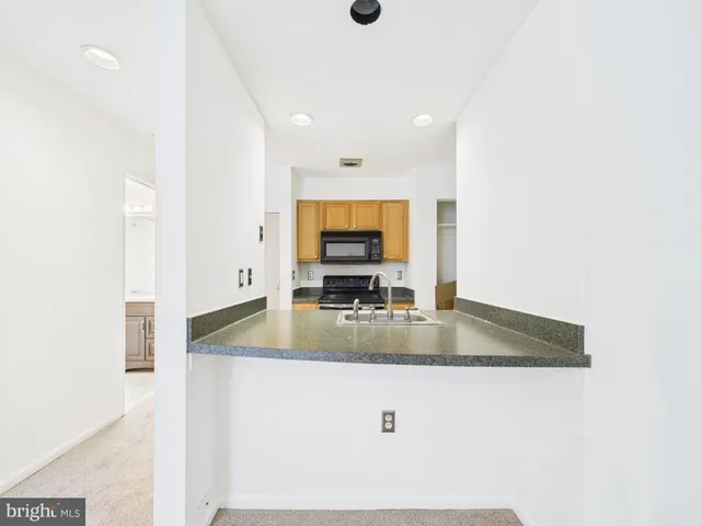 a view of kitchen island a sink and mirror