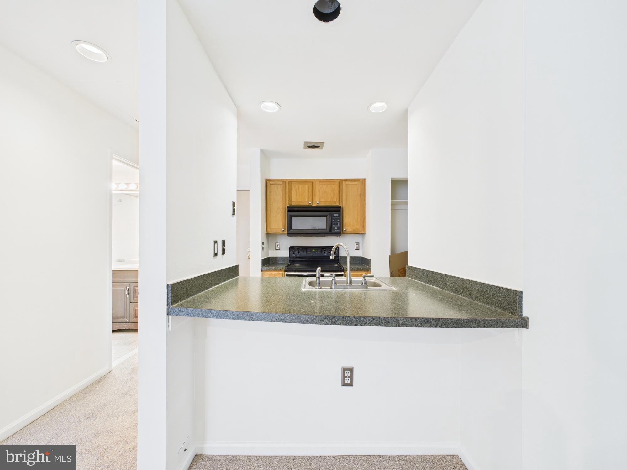 1601 Spring Garden Street, Unit 402 Philadelphia, PA 19130 - Photo 10 of 22 a view of kitchen island a sink and mirror