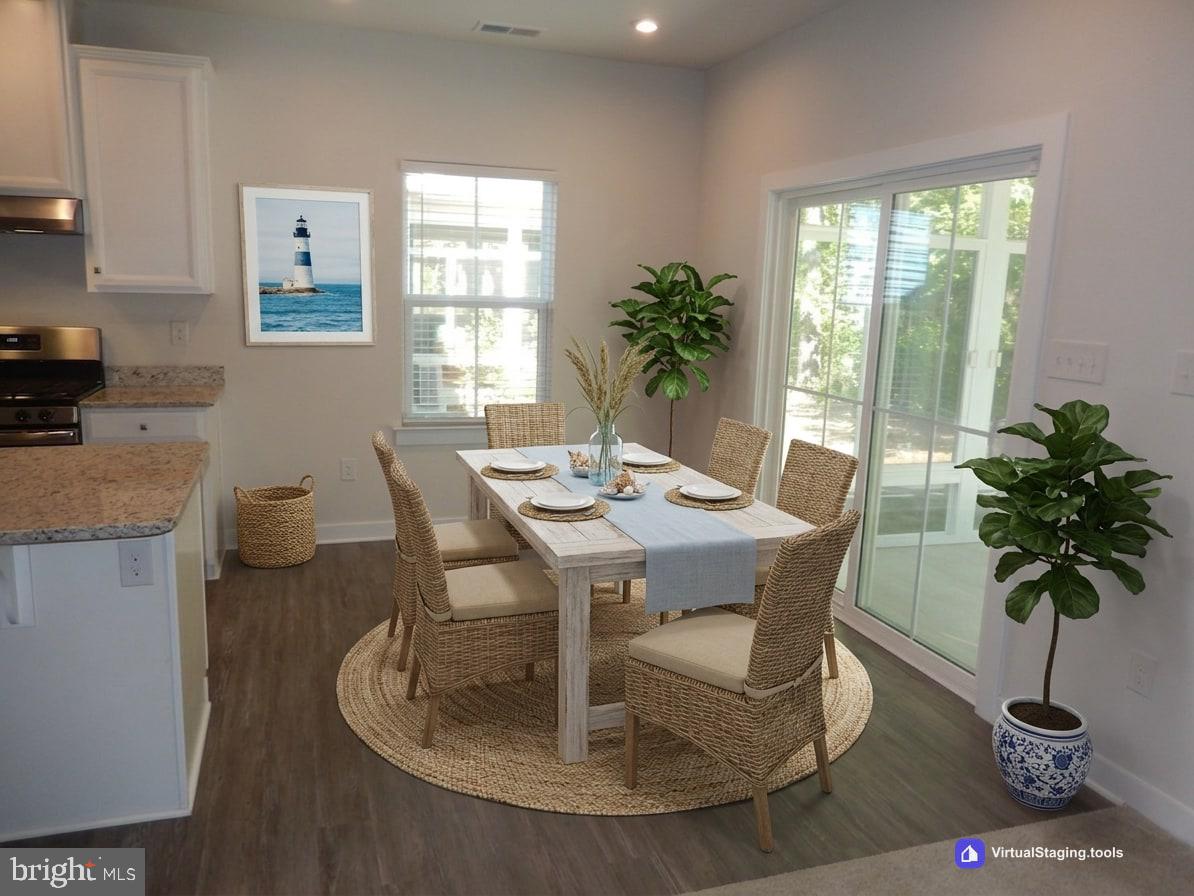 36884 Red Cedar Loop Ocean View, DE 19970 - Photo 18 of 50 a dining room with furniture potted plants and wooden floor