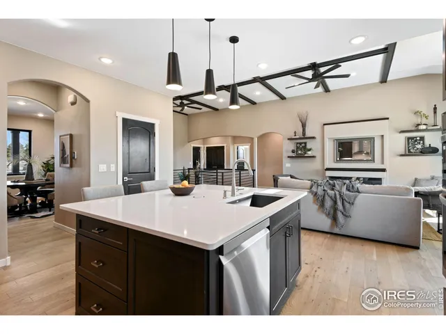 a view of kitchen island with sink and wooden floor