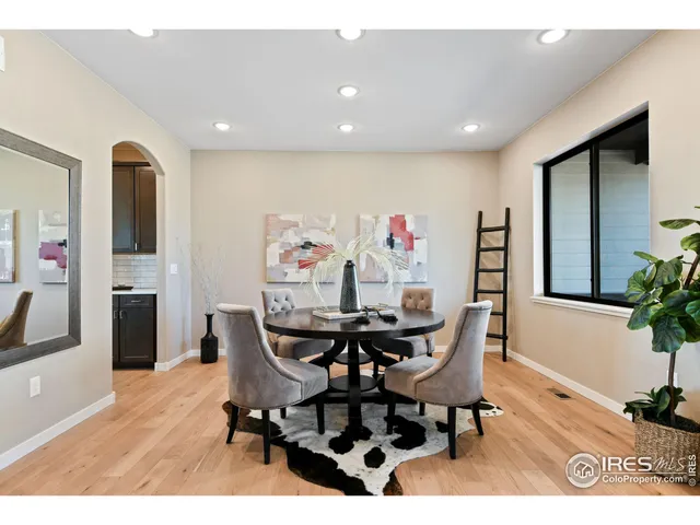 a view of a dining room with furniture and a potted plant