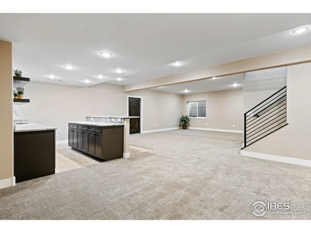 a kitchen with a counter top space cabinets and wooden floor