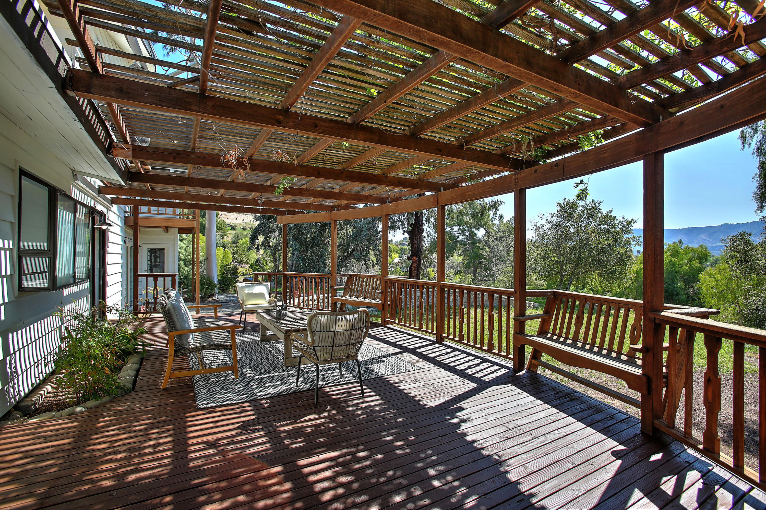 2080 Maricopa Highway Ojai, CA 93023 - Photo 18 of 47 a view of a patio with table and chairs and wooden floor