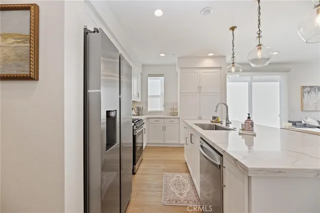 a large white kitchen with a large window