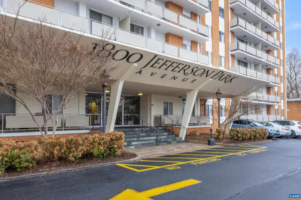 a view of a building with car parked