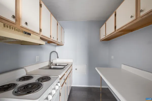 a kitchen with stainless steel appliances a sink a stove and a microwave