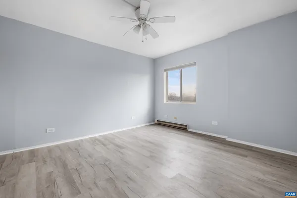 a bedroom with a bed and a potted plant
