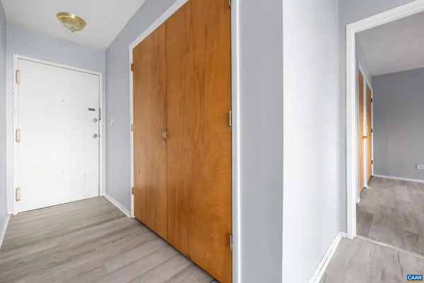 a view of a hallway with wooden floor