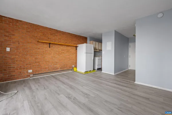 a view of an empty room with wooden floor