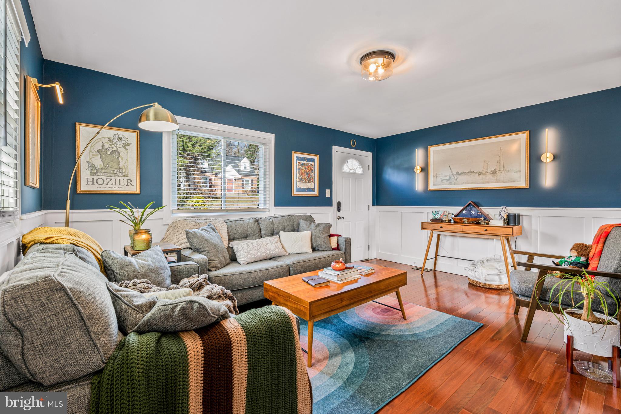 a living room with furniture fireplace and a large window