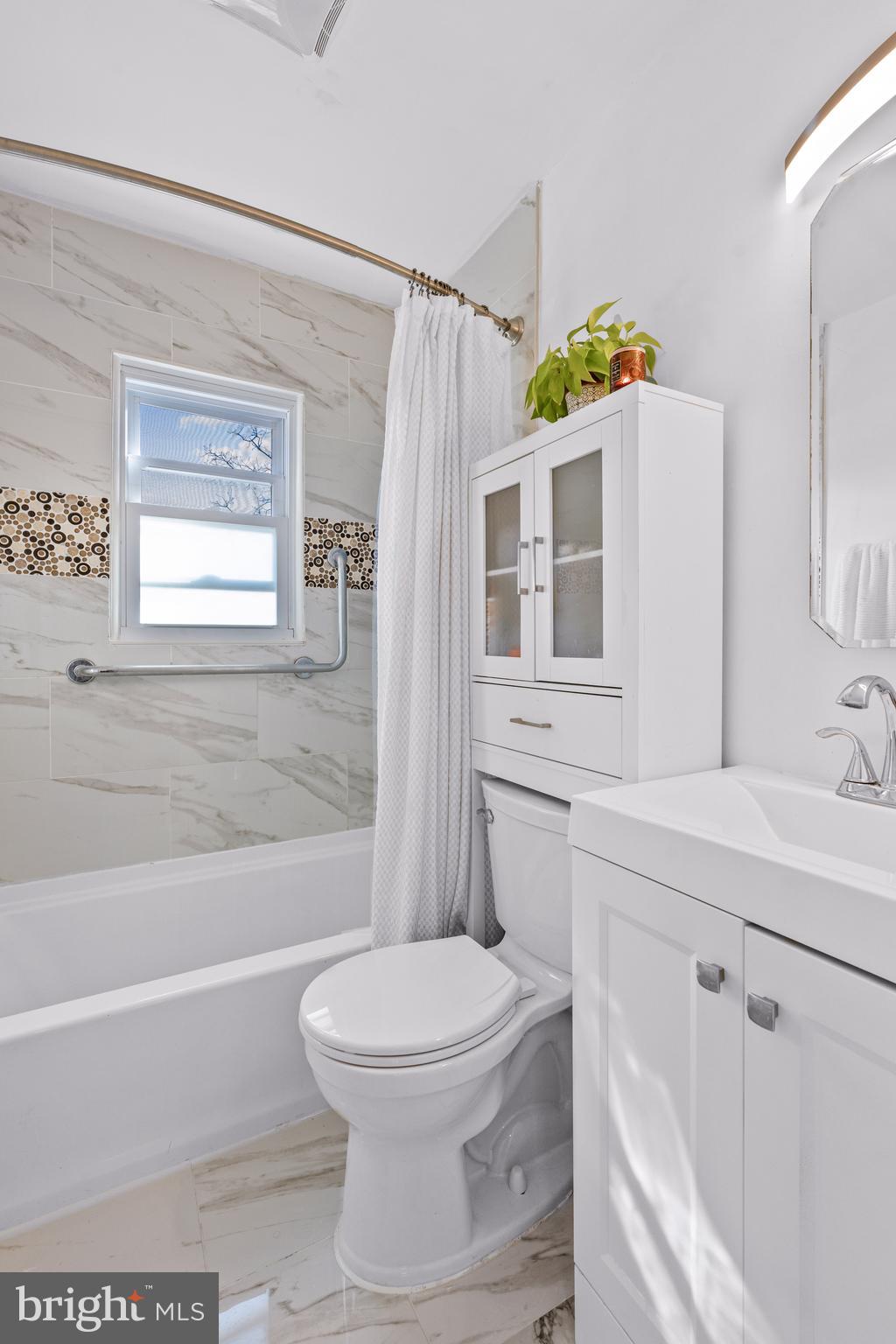 7745 Garrison Road Hyattsville, MD 20784 - Photo 15 of 43 a bathroom with a sink a toilet and shower