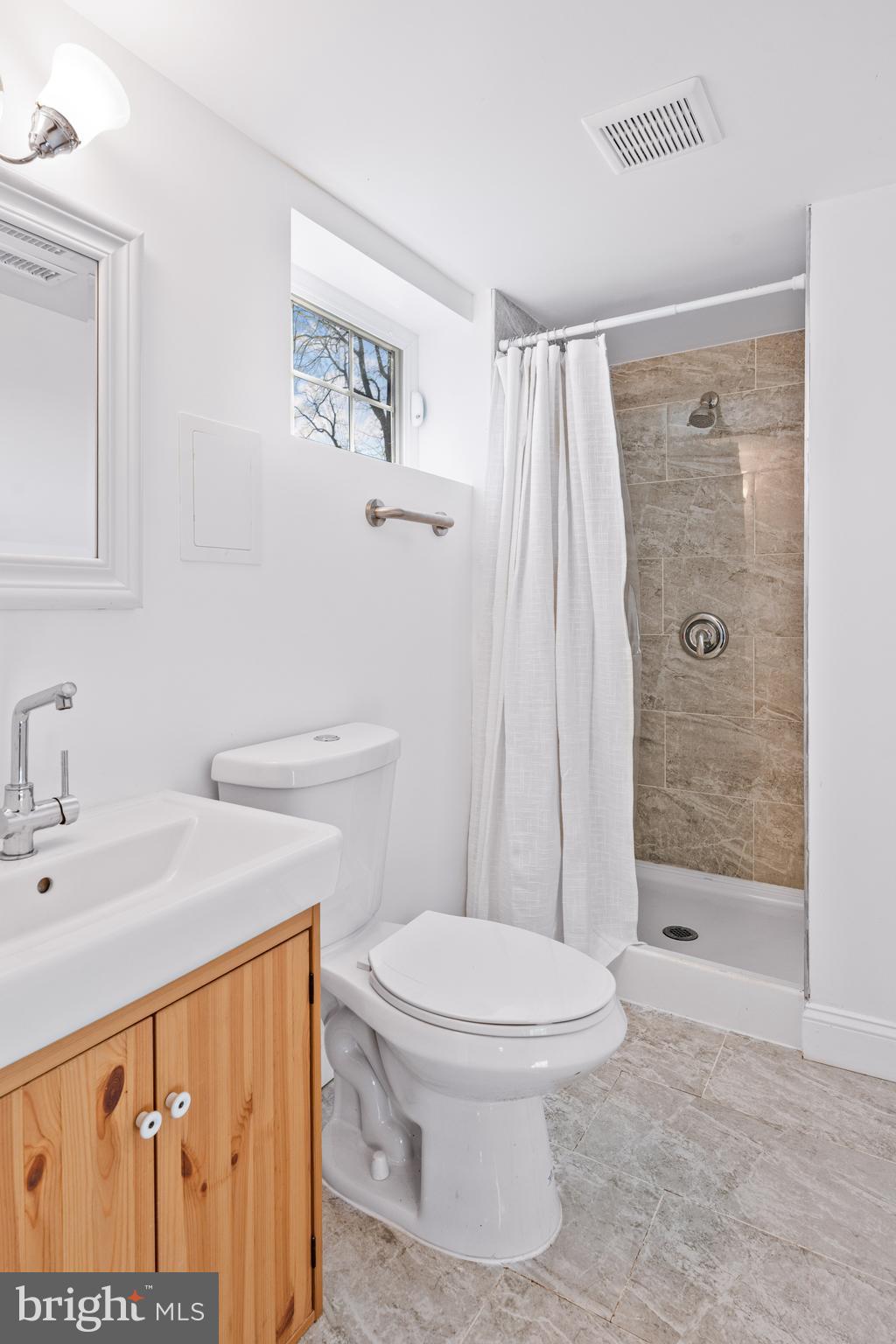 7745 Garrison Road Hyattsville, MD 20784 - Photo 27 of 43 a bathroom with a sink a toilet and shower