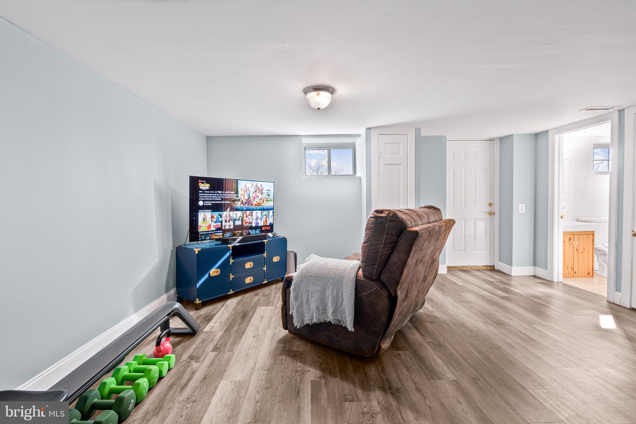 7745 Garrison Road Hyattsville, MD 20784 - Photo 31 of 43 a living room with furniture and a flat screen tv