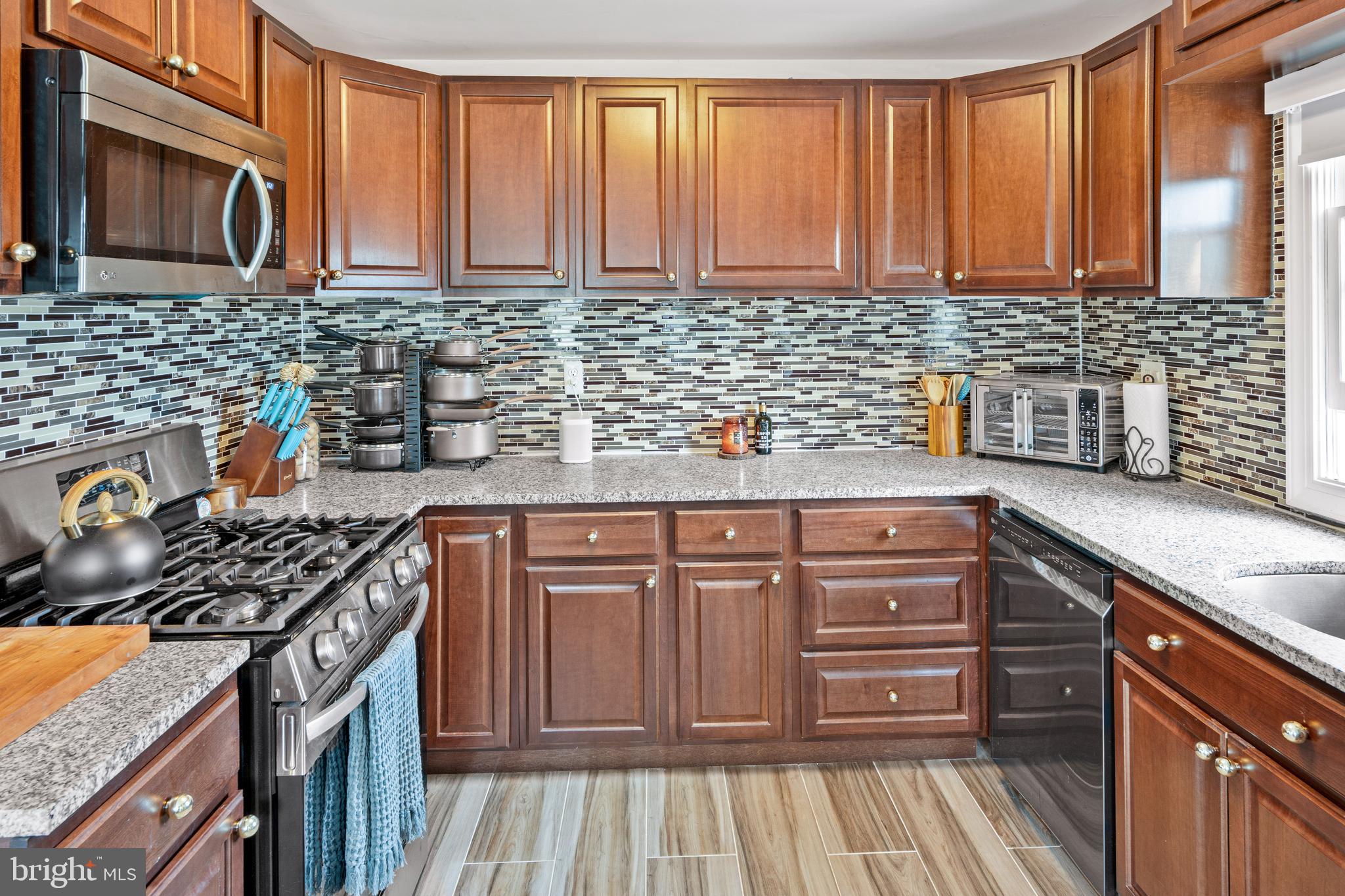 7745 Garrison Road Hyattsville, MD 20784 - Photo 35 of 43 a kitchen with stainless steel appliances granite countertop a stove and a sink