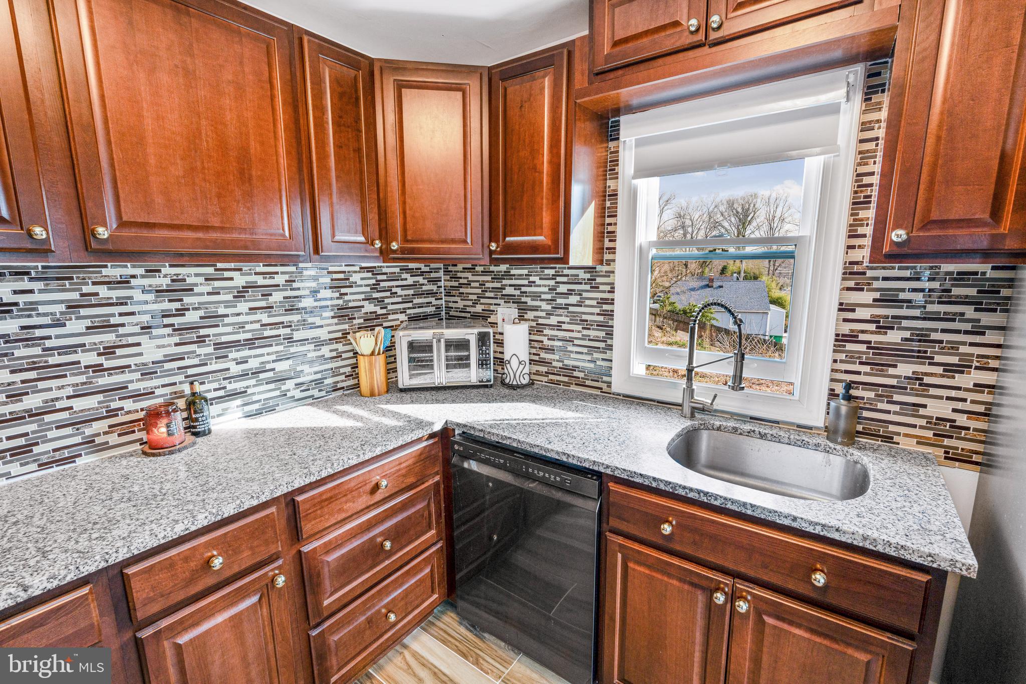 7745 Garrison Road Hyattsville, MD 20784 - Photo 36 of 43 a kitchen with stainless steel appliances granite countertop a sink stove and cabinets