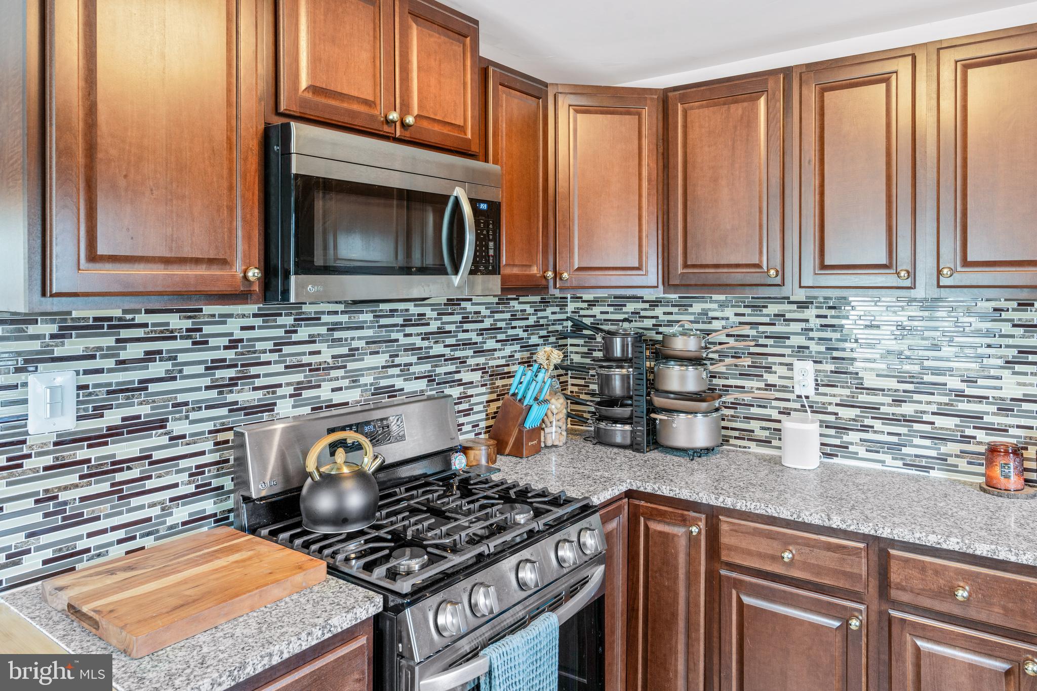 7745 Garrison Road Hyattsville, MD 20784 - Photo 10 of 43 a kitchen with granite countertop a stove sink and cabinets