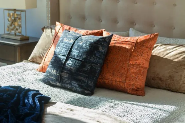a bed sitting in a bedroom next to a lamp