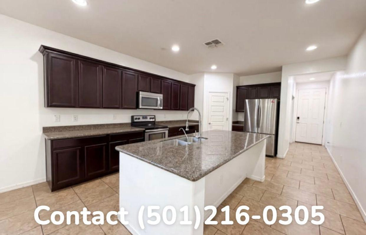 602 West Beautiful Lane Phoenix, AZ 85041 - Photo 3 of 7 a kitchen with granite countertop a sink and a refrigerator