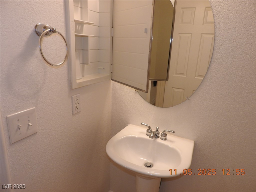 240 Rustic Club Way Las Vegas, NV 89148 - Photo 12 of 40 Bathroom with a textured wall and a sink