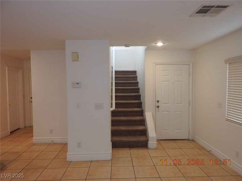 240 Rustic Club Way Las Vegas, NV 89148 - Photo 13 of 40 Stairway with tile patterned flooring and baseboards