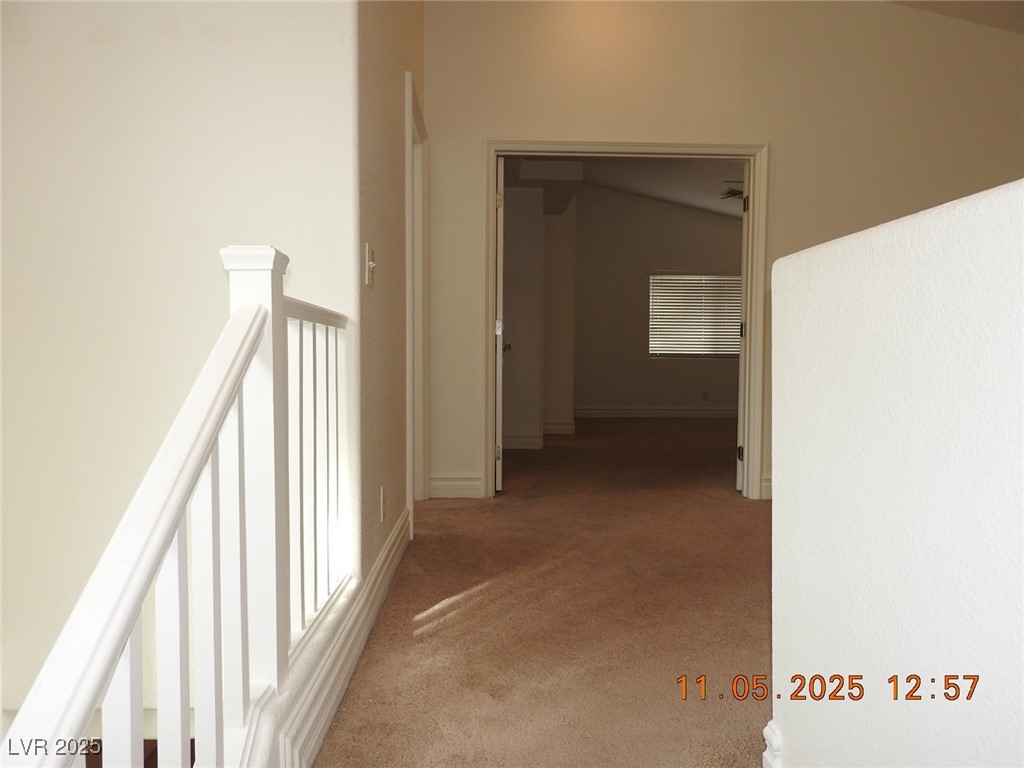 240 Rustic Club Way Las Vegas, NV 89148 - Photo 15 of 40 Hall featuring light colored carpet and an upstairs landing