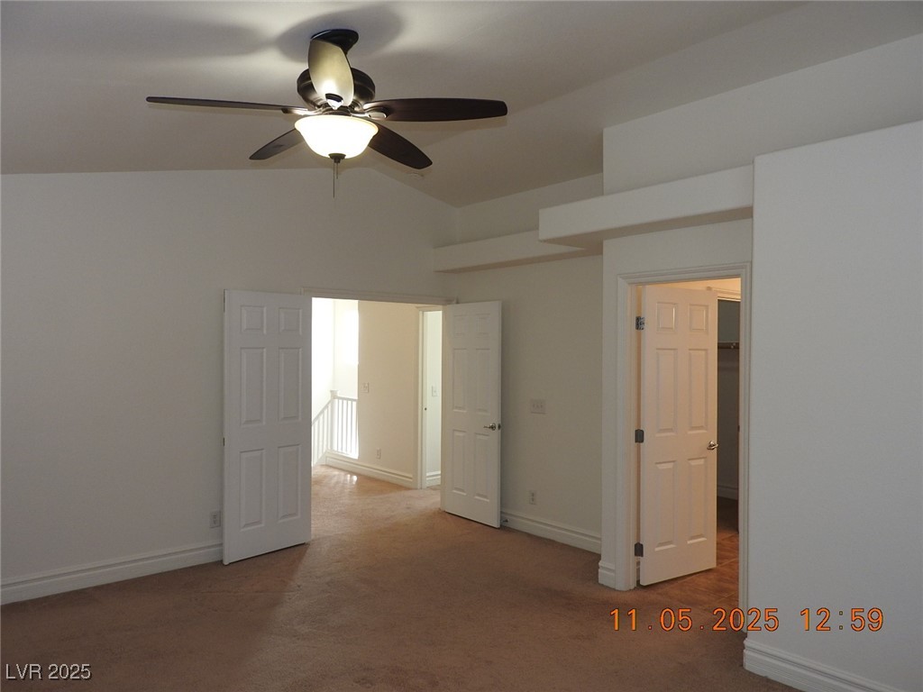 240 Rustic Club Way Las Vegas, NV 89148 - Photo 20 of 40 Unfurnished bedroom featuring carpet floors, lofted ceiling, and ceiling fan