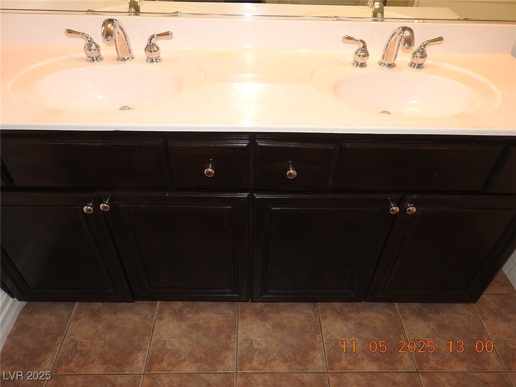 240 Rustic Club Way Las Vegas, NV 89148 - Photo 22 of 40 Bathroom with dark tile patterned flooring and double vanity