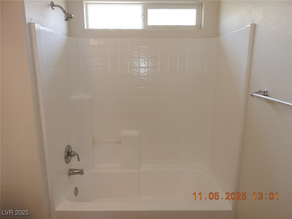 240 Rustic Club Way Las Vegas, NV 89148 - Photo 27 of 40 Bathroom with a textured wall and shower / tub combination