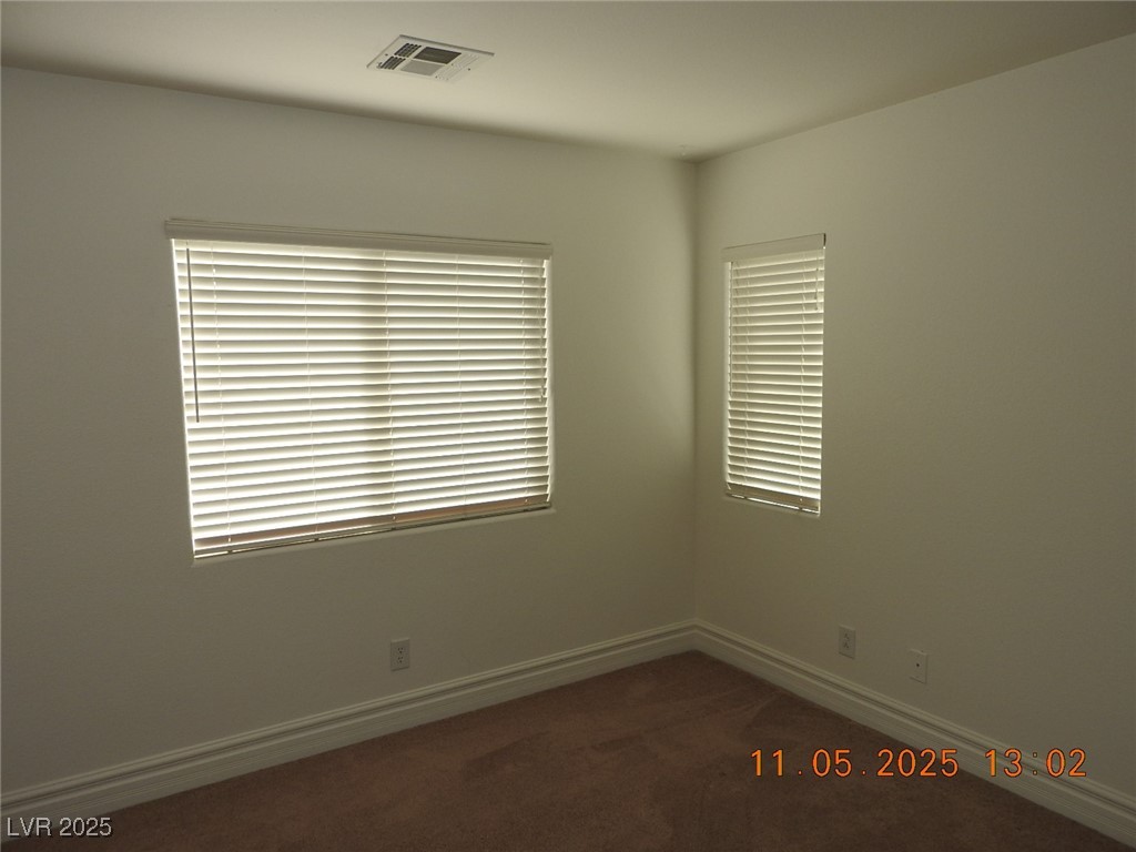 240 Rustic Club Way Las Vegas, NV 89148 - Photo 30 of 40 Spare room featuring dark colored carpet and baseboards