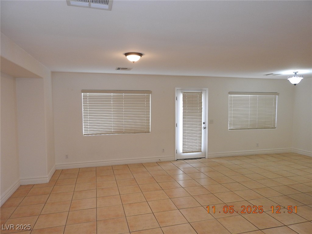 240 Rustic Club Way Las Vegas, NV 89148 - Photo 5 of 40 Spare room with light tile patterned floors and baseboards