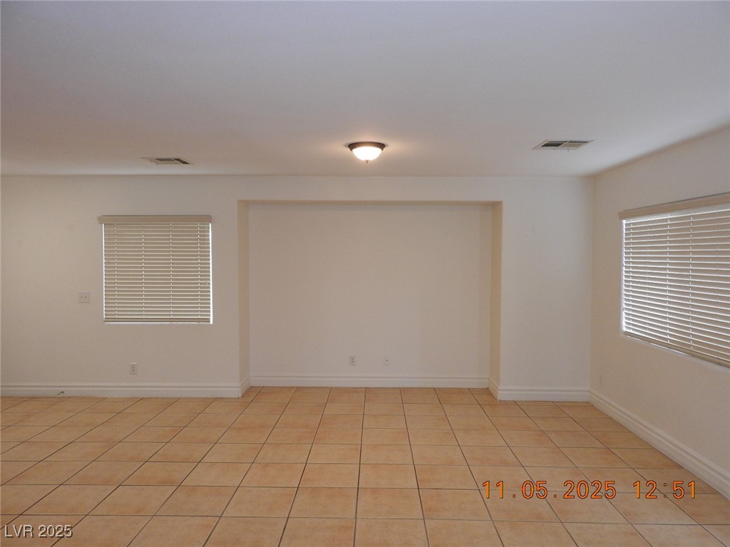 240 Rustic Club Way Las Vegas, NV 89148 - Photo 6 of 40 Spare room featuring light tile patterned flooring