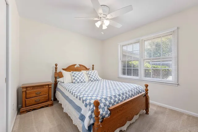 a bed sitting in a bedroom next to a window