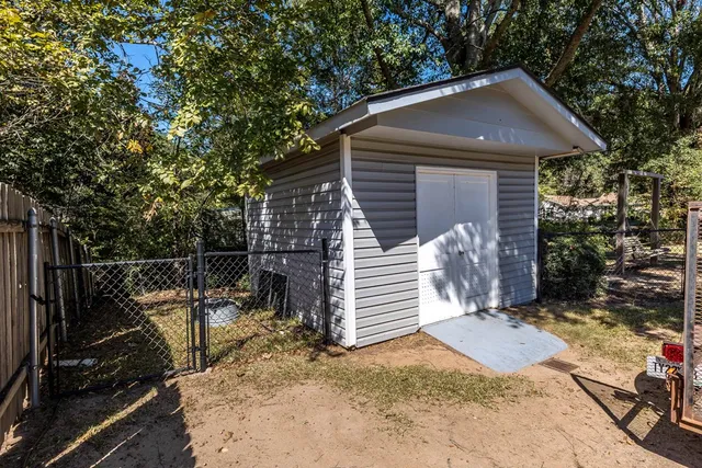 a view of a small house with garage