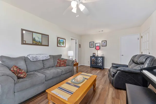 a living room with furniture and a wooden floor