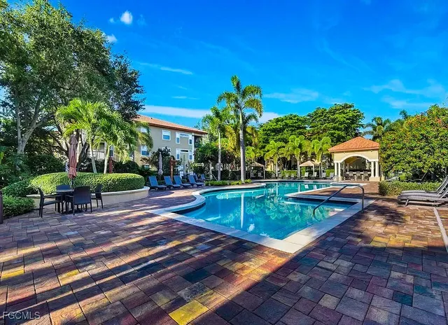 a view of a house with swimming pool and sitting area