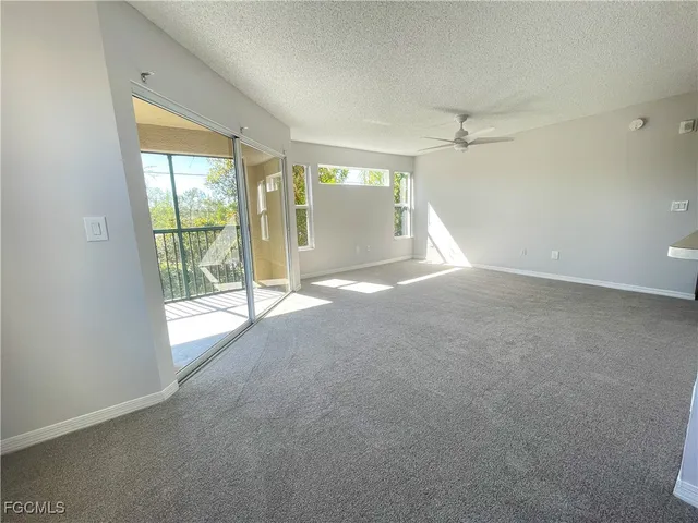 en empty room with windows and city view