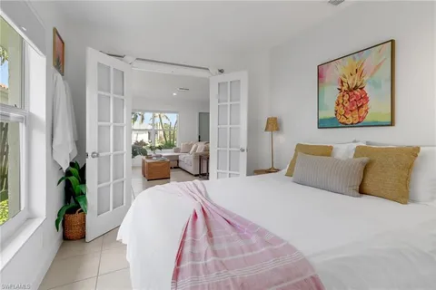 a bedroom with a bed and a potted plant