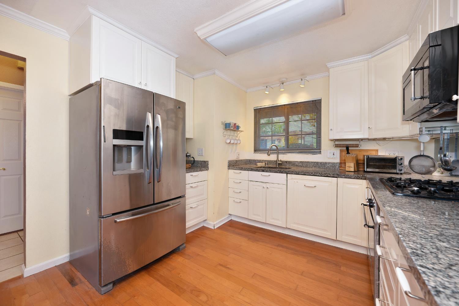 6430 Sandstone Street Carmichael, CA 95608 - Photo 11 of 39 a kitchen with stainless steel appliances a refrigerator sink and microwave