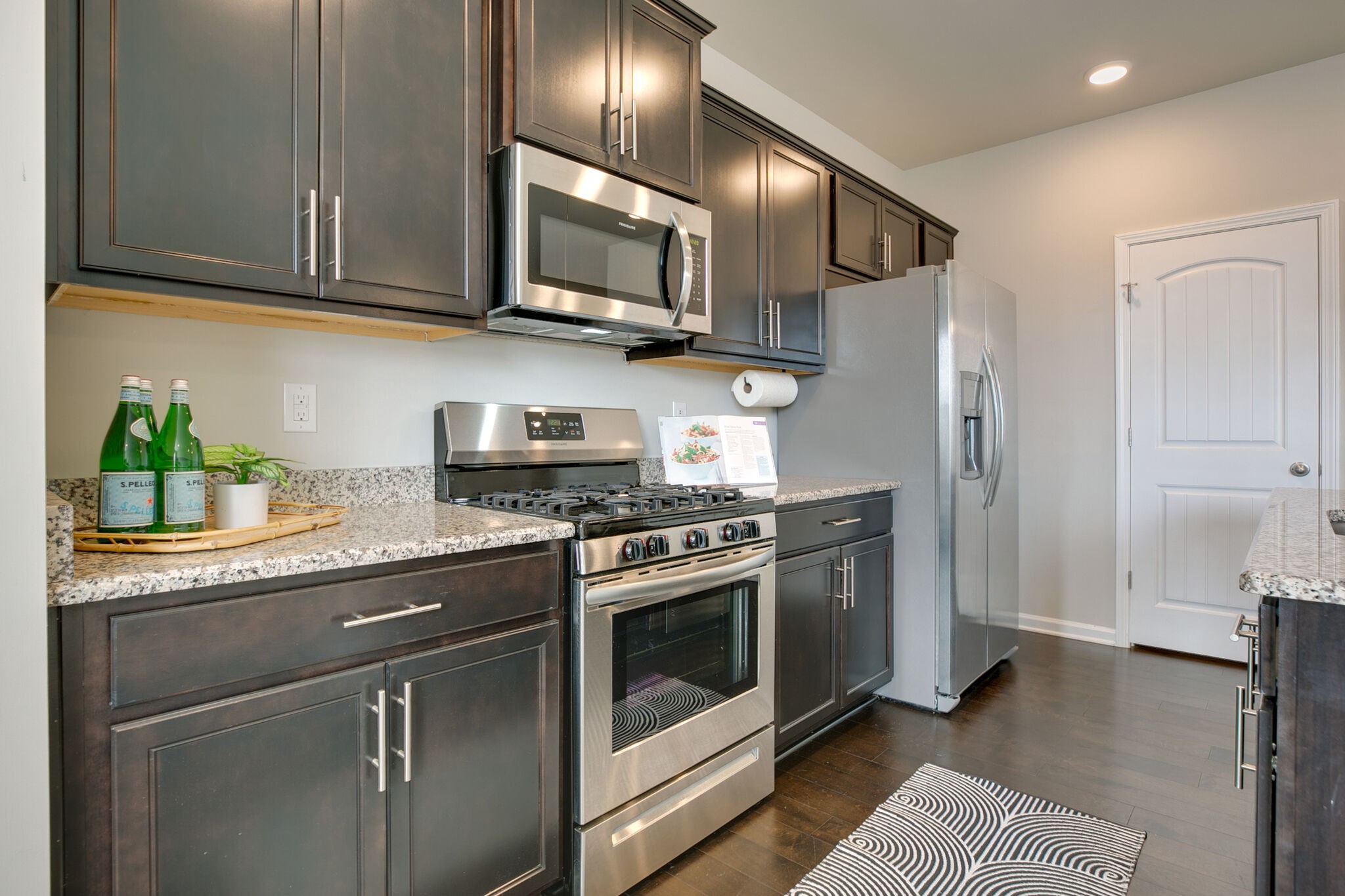 4283 Grapevine Loop Smyrna, TN 37167 - Photo 12 of 30 a kitchen with stainless steel appliances granite countertop a stove a refrigerator and a sink