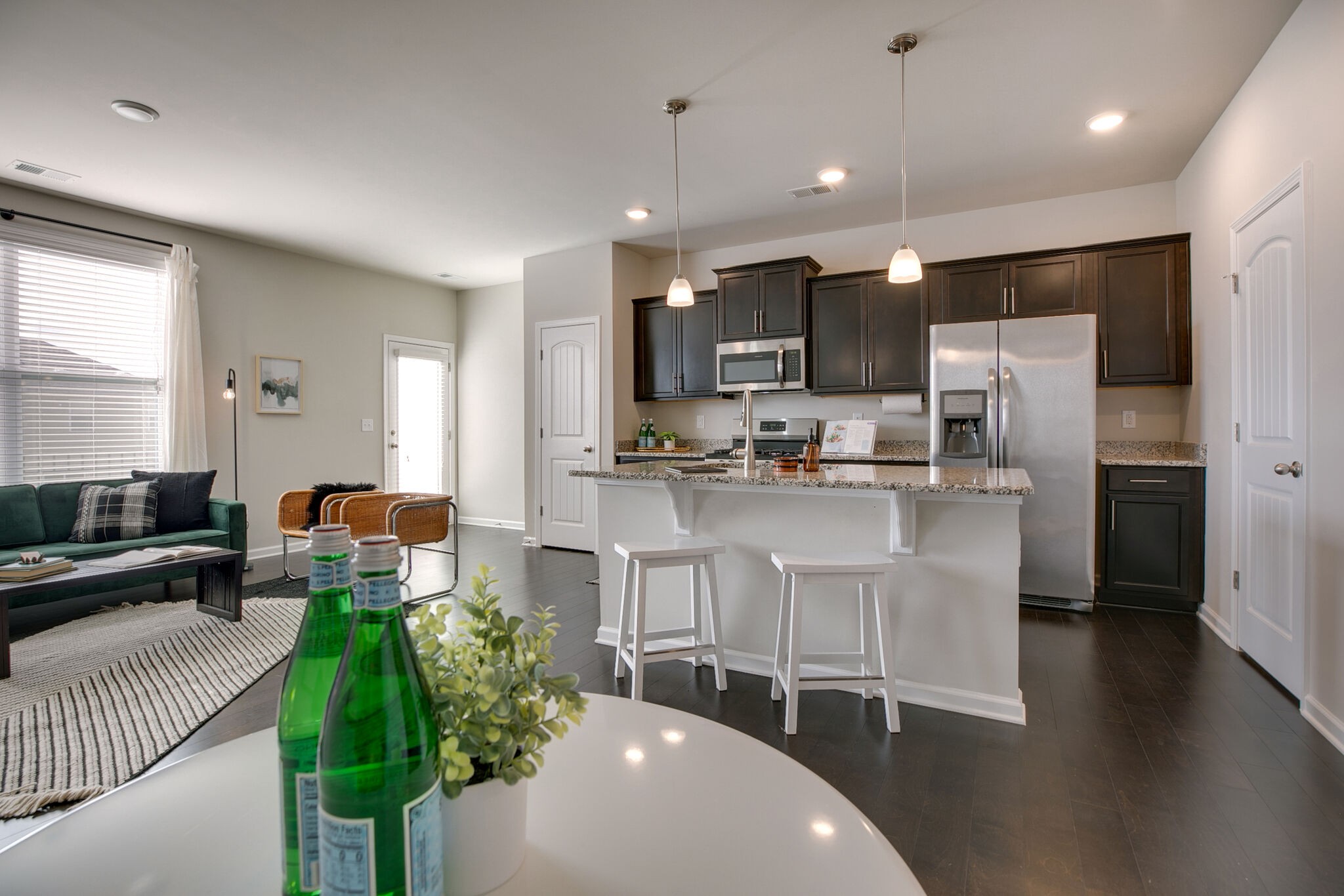 4283 Grapevine Loop Smyrna, TN 37167 - Photo 14 of 30 a kitchen with stainless steel appliances kitchen island granite countertop a refrigerator a stove a sink dishwasher and a fireplace with wooden floor