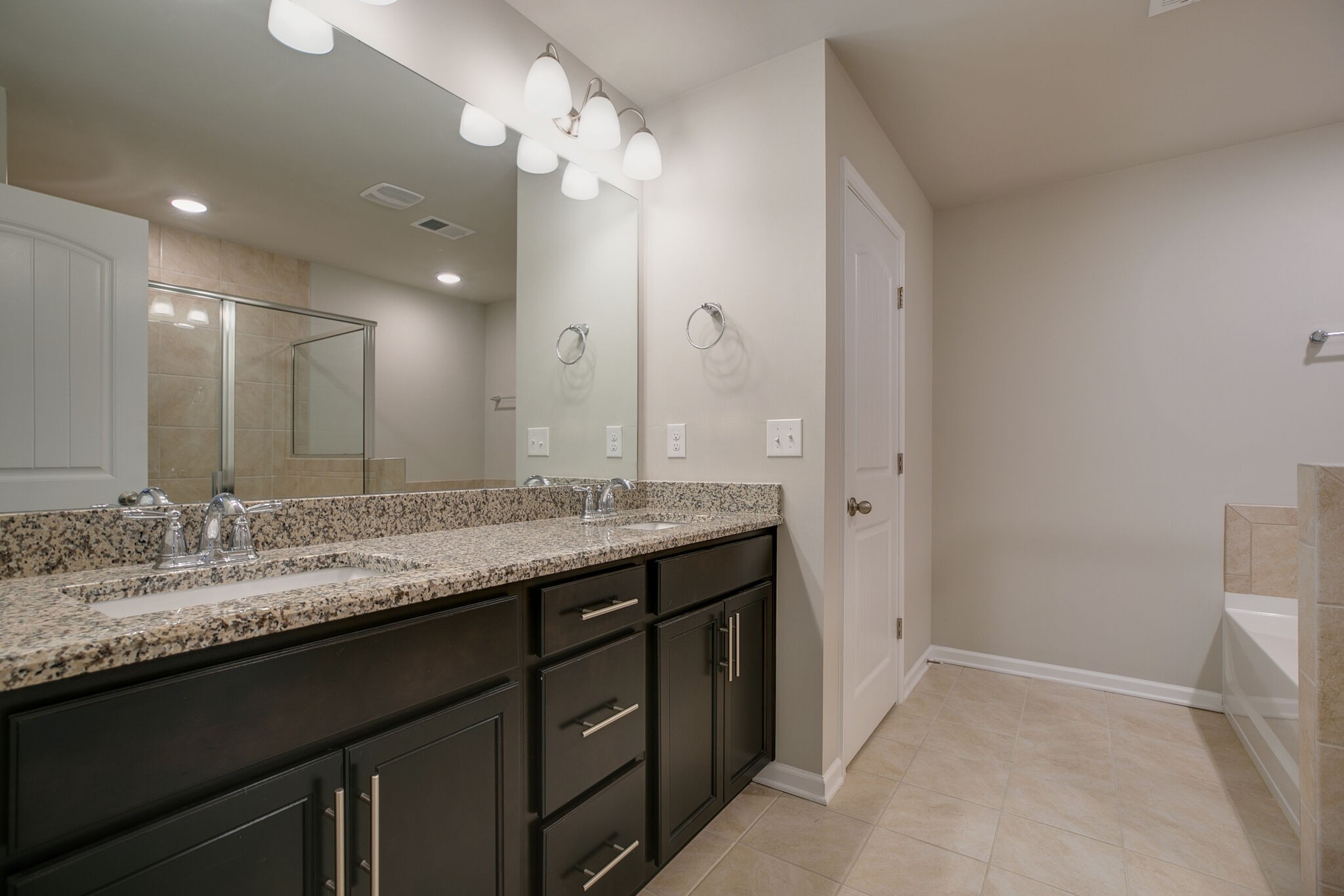 4283 Grapevine Loop Smyrna, TN 37167 - Photo 19 of 30 a bathroom with a granite countertop sink a large mirror and a shower