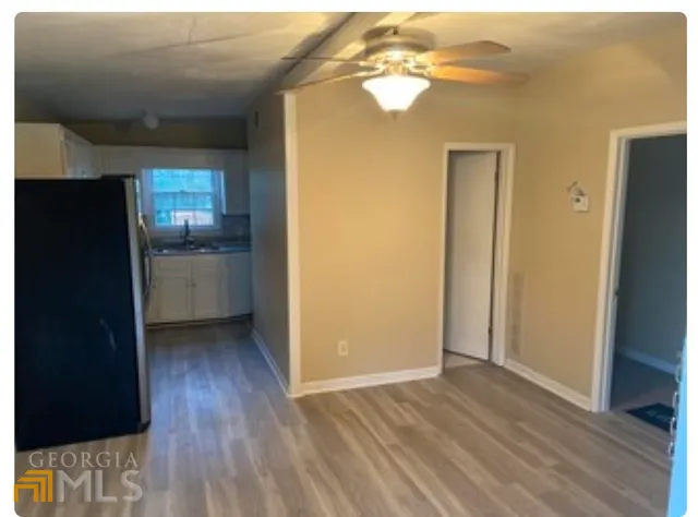 a view of empty room with wooden floor